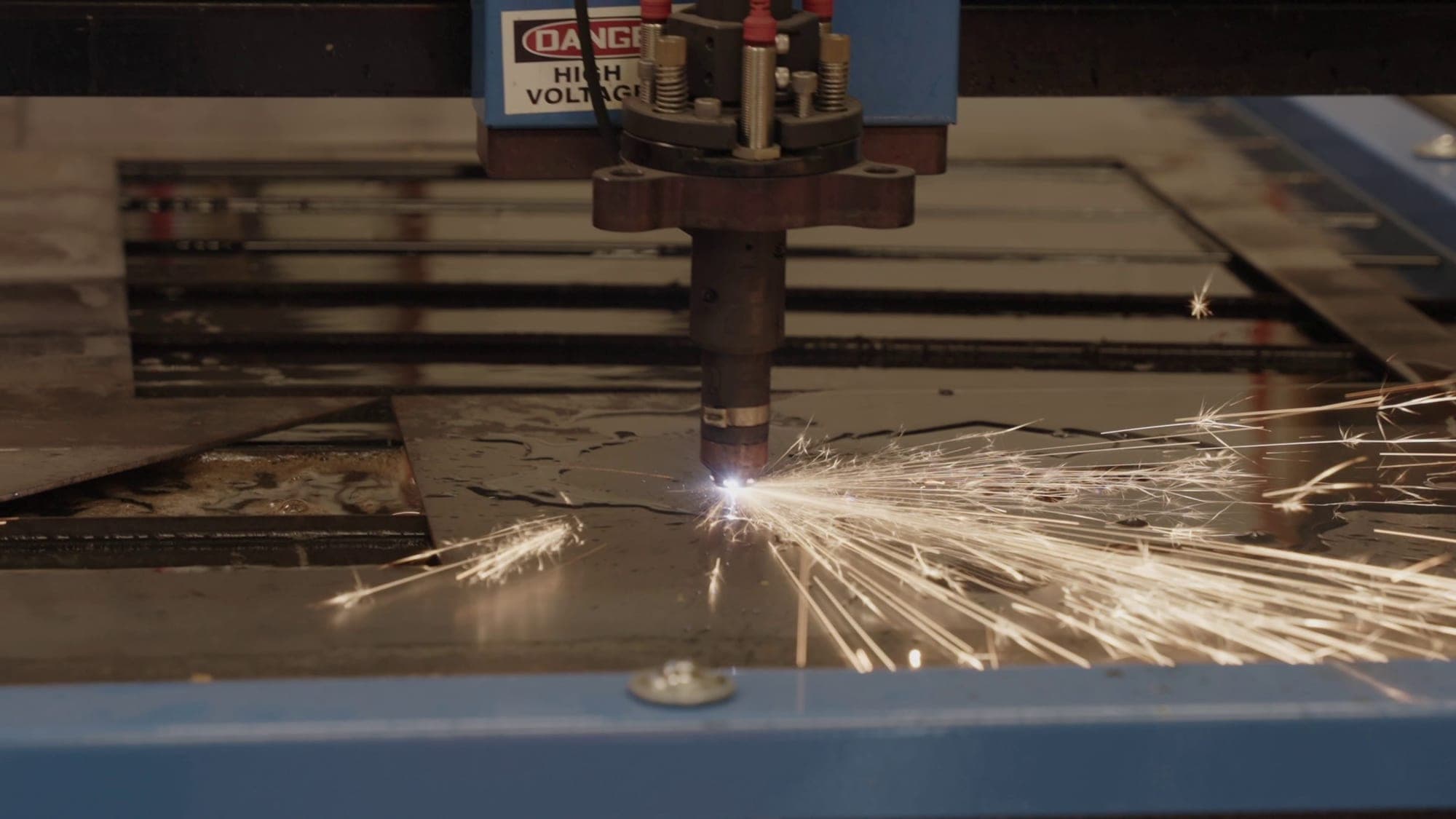A CNC plasma cutter cutting steel plate in the Highland Prep West fabrication shop